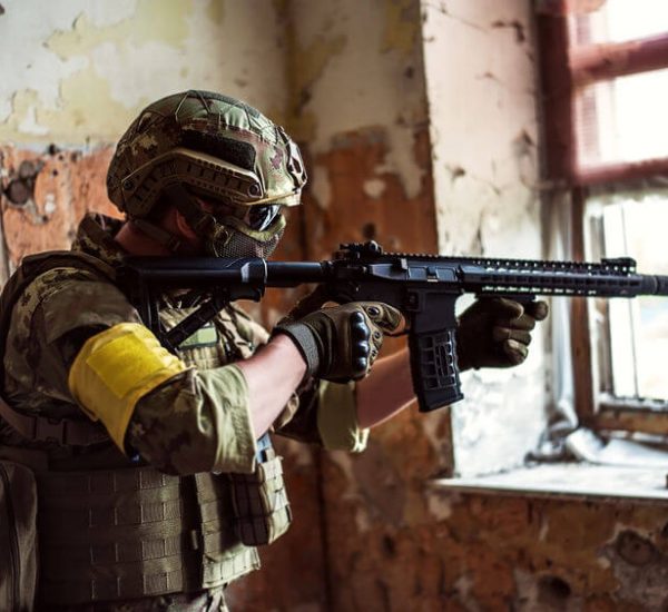 airsoft sniper with automatic rifle and mask