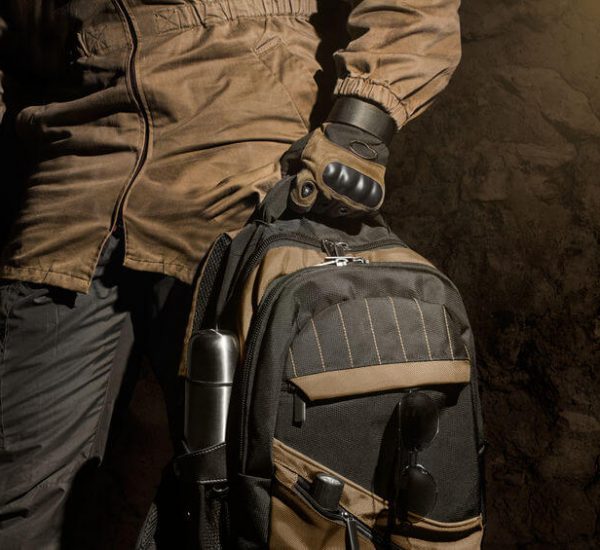 man holding a military tactical backpack