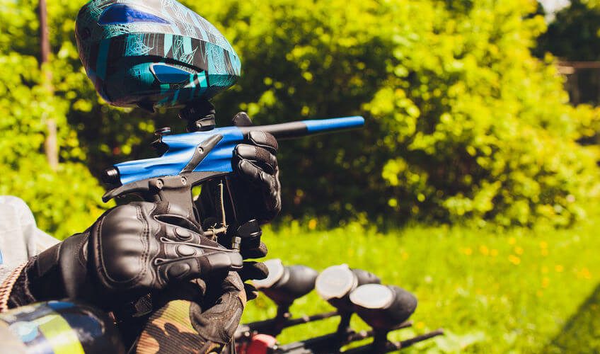 man in paintball area holding his paintball gun