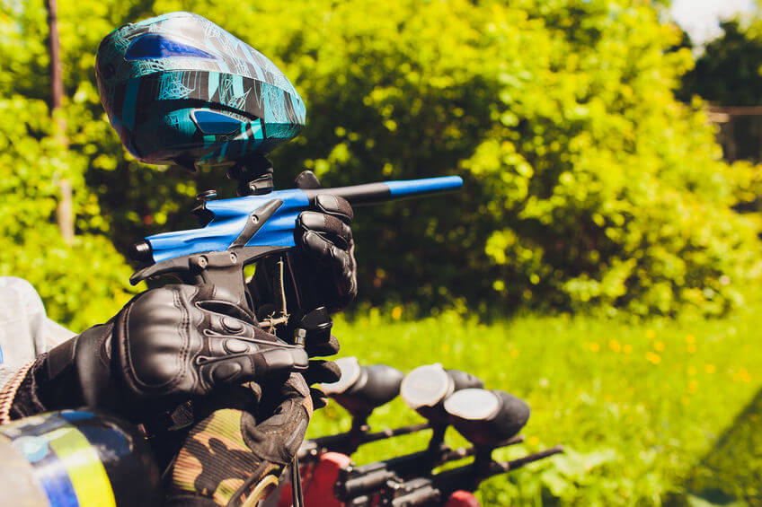man in paintball area holding his paintball gun
