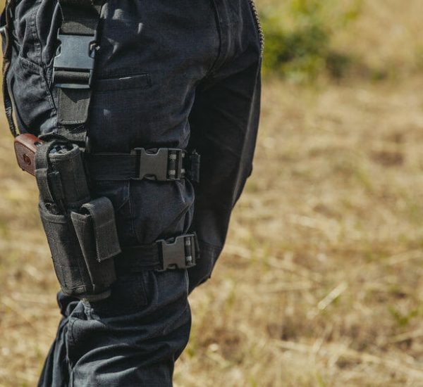 gun hidden in tactical holster hanging on a soldiers leg