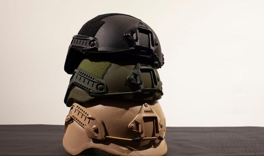 three military tactical helmets on white background