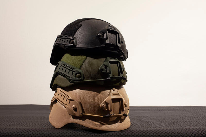 three military tactical helmets on white background