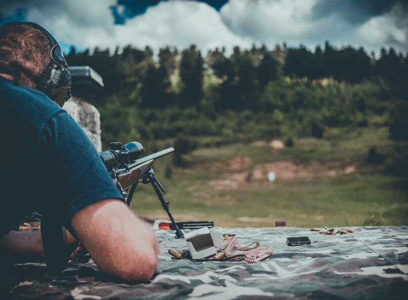 man with a long barrel gun on shooting range