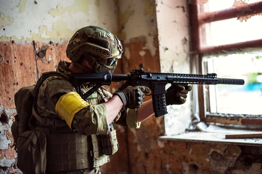 airsoft sniper with automatic rifle and mask