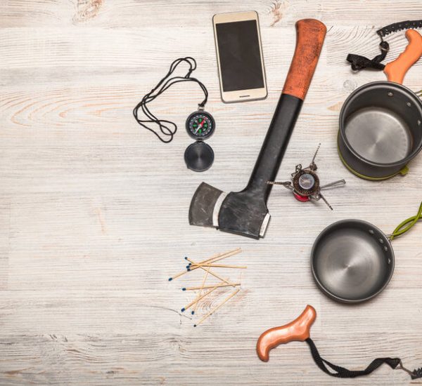 backpacking saw and other gear on table