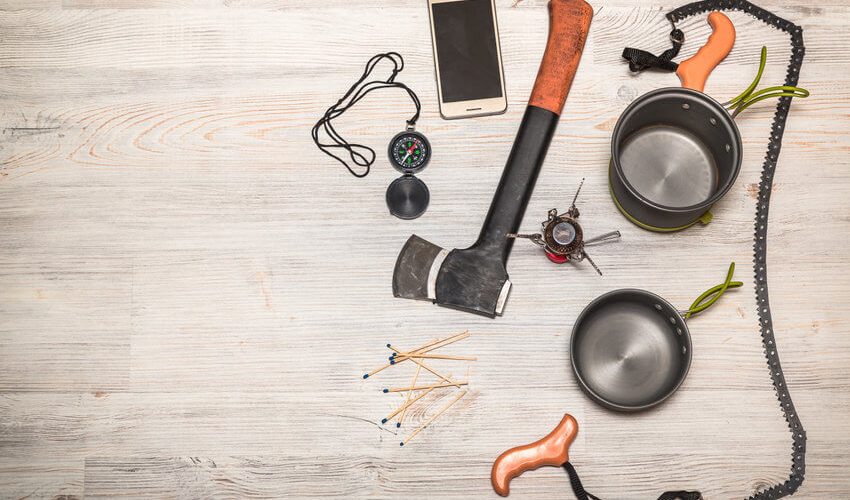 backpacking saw and other gear on table