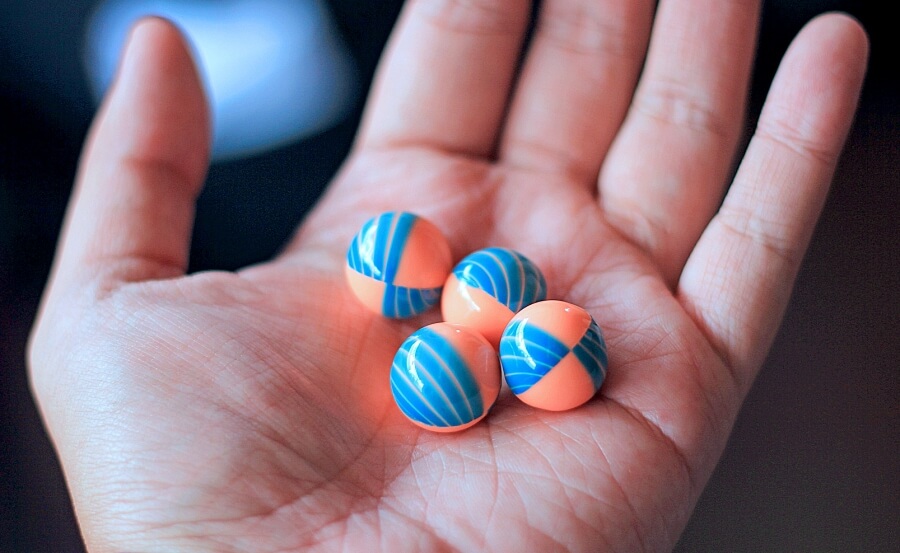 coloured paintball pellets in hand