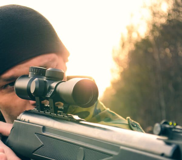 man aiming an airgun