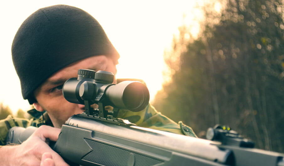 man aiming an airgun