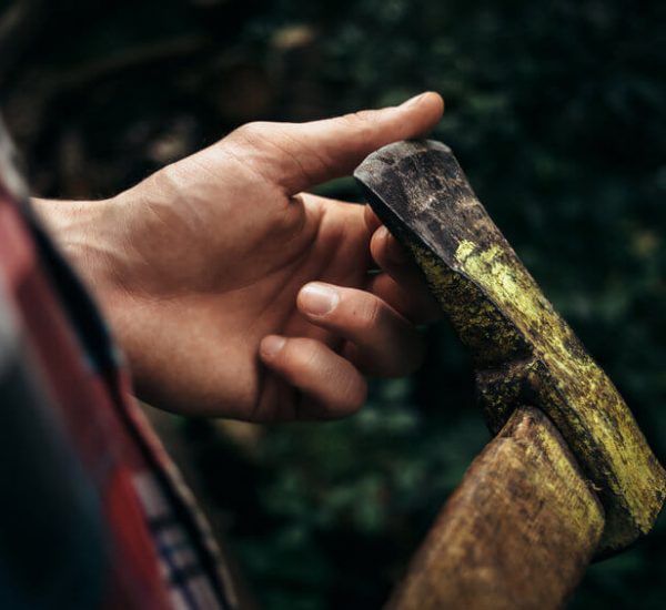 man holding a camping axe