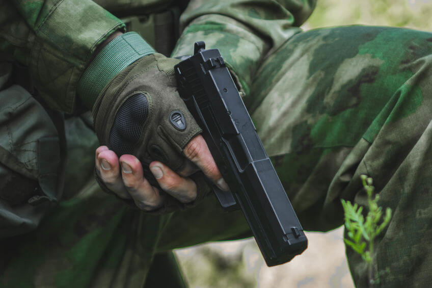 man holding airsoft pistol in hands