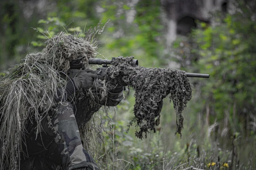 man playing sniper role in airsoft game