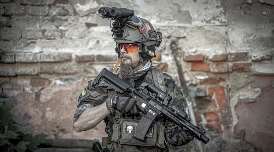 man wearing tactical gear and holding airsoft rifle