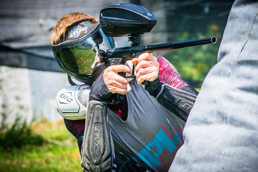 paintball player shooting with electronic paintball marker