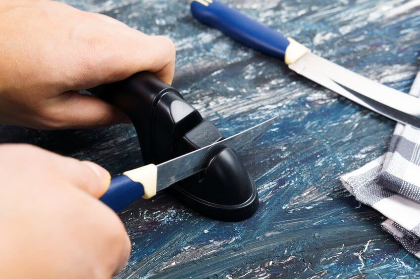 person sharpening a knife