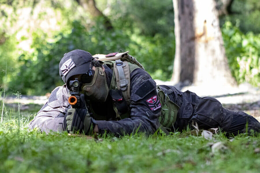 airsoft player aiming with airsoft rifle