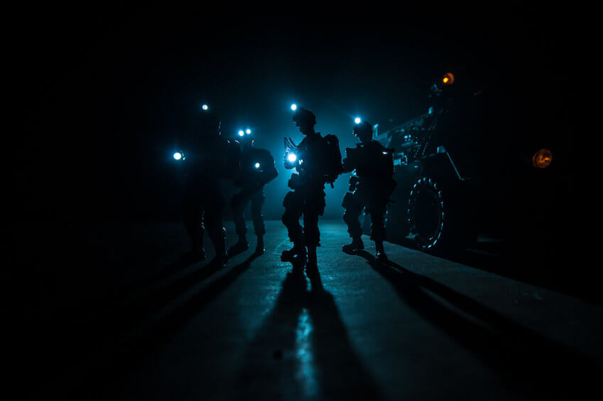 police force with flashlights in dark