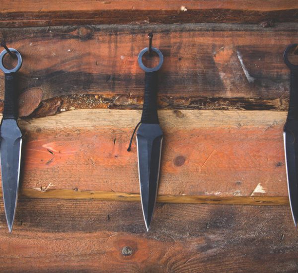 three throwing knives on table