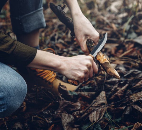 women using a bushcraft knife
