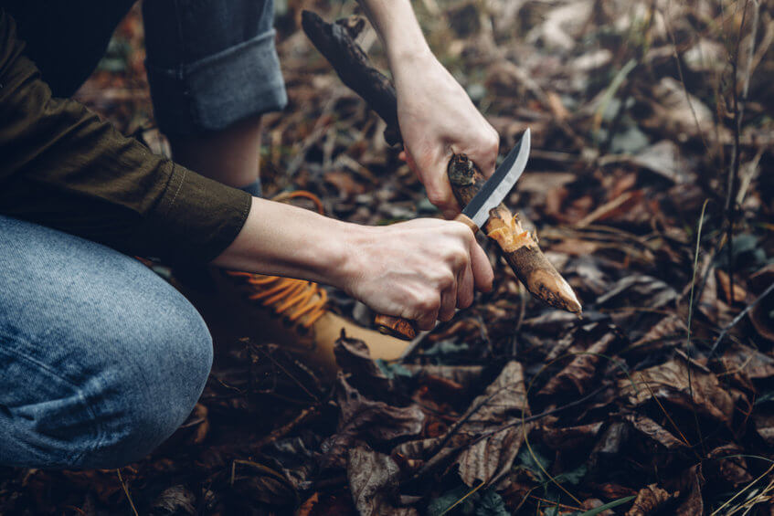 women using a bushcraft knife